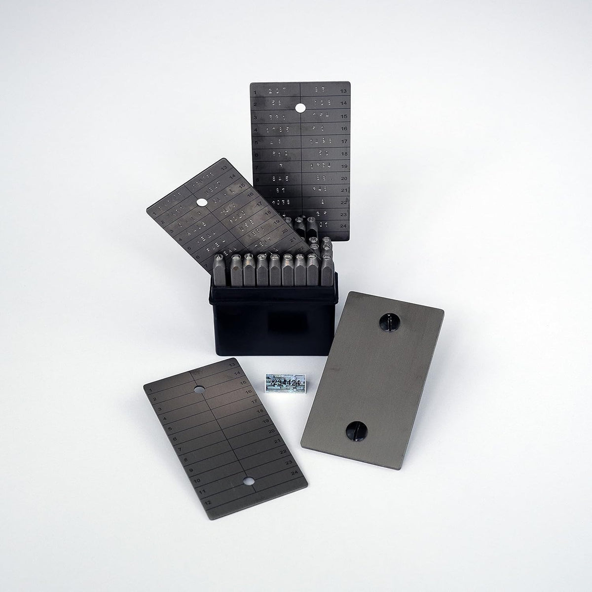 ColdTi titanium Bitcoin seed plates with punch set and seals for secure crypto seed phrase storage, featuring alphabetic punch tools.
