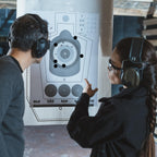 ChromaLabel 0.75-inch round black target pasters for shooting, 1000 labels per dispenser box, used in marksmanship training.