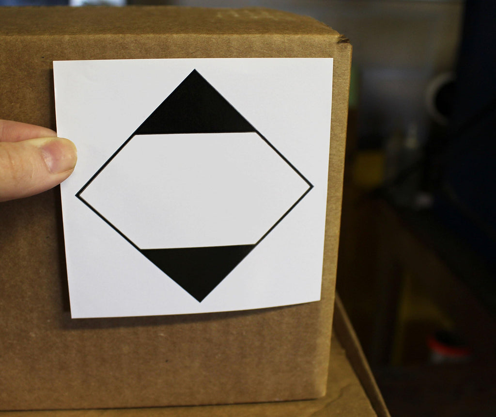 ChromaLabel 4x4 inch ground ORM-D shipping labels on a roll, industrial labels for safe packaging and transport.