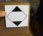 ChromaLabel 4x4 inch ground ORM-D shipping labels on a roll, industrial labels for safe packaging and transport.
