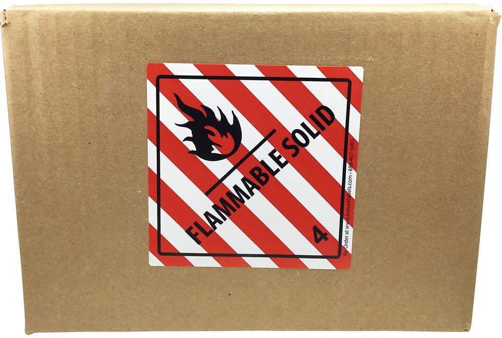 Red and white hazard class 4 D.O.T. flammable solid labels on a roll, 4x4 inch color-coding stickers for shipping compliance.