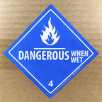 Laminated Dangerous When Wet hazard class 4 D.O.T labels, 4x4 inch square stickers on a roll, suitable for safety signage.
