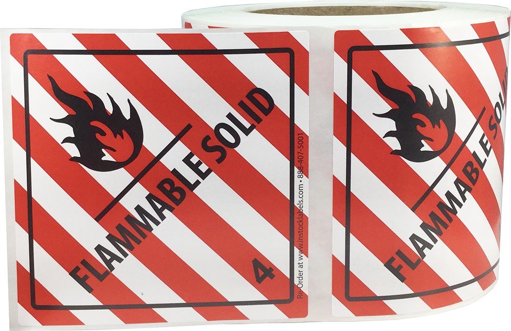 Red and white Hazard Class 4 D.O.T. flammable solid labels, 4x4 inch adhesive stickers on a roll for shipping compliance.