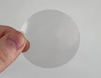 ChromaLabel 2-inch clear round wafer seals on a roll, showing glossy, transparent adhesive seals for packaging or labeling.